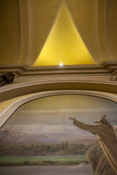 an arch, a light and a fresco painting in the church san francesco in san marino in italy