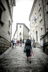 an elegant italian women is going up a street in san marino in italy