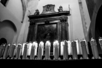electric candles in the church santa maria assunta in bovino in italy, black-and-white
