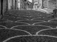 a nice architectural street with white houses in bovino in puglia, black-and-white