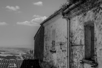 an old wheathered house with a view in the landscape around the village bovino in puglia, black-and-white