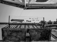 looking up to a balkon, on that ist hanging a clothes line with clothes in the village bovino in italy, black-and-white