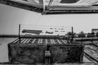 looking up to a balkon, on that ist hanging a clothes line with clothes in the village bovino in italy, black-and-white