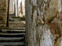 old wheathered walls and uphill going steps in the village bovino in puglia in italy