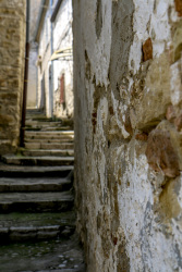 old wheathered walls and uphill going steps in the village bovino in puglia in italy