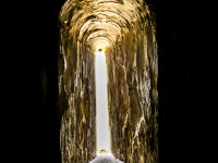 a view through a very small windows in the walls of the castel del monte in puglia in italy