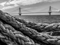 big ropes in the front of the gulf of corinth and in the background you see the rio antirrio bridge near patras, black-and-white