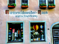 two storewindows of an art shop in a pink house in rotenburg ob der tauber in germany