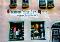 two storewindows of an art shop in a pink house in rotenburg ob der tauber in germany