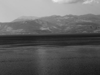 a panoramic view on the gulf of corinth and the mountains near delphi on the other side, black-and-white