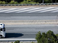 you see the truck cab of a white truck that is driving on the highway near diakopto in achaia