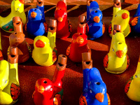 colorful water flutes in form of birds in the evening light on the island of ioannina in greece
