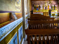church chairs, frescoes and police officers in hall of the mega spileo near kalavrita