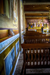church chairs, frescoes and police officers in hall of the mega spileo near kalavrita
