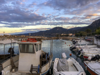 boats at the little harbor in diakopto at evening light
