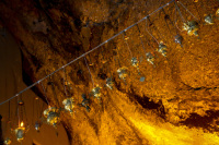 incense vessels are hanging in the golden lighted cave of mega spileon near kalavrita
