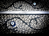 black and white mosaic and a blue nazar on rhodes