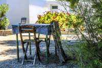 in a tavern in glyfada on rhodes stands a idyllic wooden seating group with a table and two chairs
