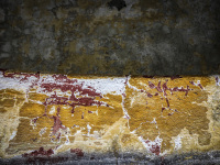 a weatherde wall in eleousa on rhodes looks like a painint in yello, white, grey and red