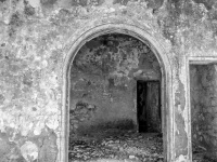 old walls with a round arch in eleousa on rhodes, black-and-white
