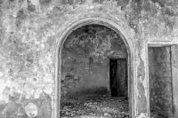 old walls with a round arch in eleousa on rhodes, black-and-white