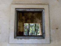 through an open window you see an open window in a ruin in eleousa on rhodes