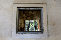 through an open window you see an open window in a ruin in eleousa on rhodes