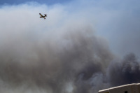 a fire plane above a very big clowd of smoke at the fire in kiotari on rhodes in 2023