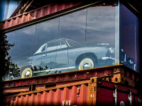 a blue oldtimer is standing in a red container with glass at the ps speicher in einbeck in germany