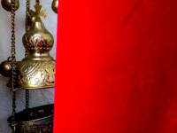 golden incense barrel next to a red curtain in the church agia marina on rhodes