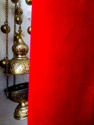 golden incense barrel next to a red curtain in the church agia marina on rhodes