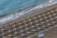 parasols and sunbeds are standing lined up in order at the beach akti kanari in ialysos on rhodes