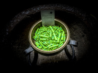 little green paper rolls laying in a bronze coloured bowl in the church in einbeck in germany