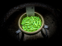 little green paper rolls laying in a bronze coloured bowl in the church in einbeck in germany