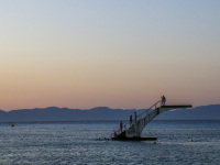 the diving plattform in the sea at the elli beach in rhodes city by sunsetlight