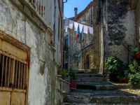 in a leading upwards alley in the village bovino in puglia are hanging clothes on a clothing line in the sun