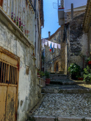 in a leading upwards alley in the village bovino in puglia are hanging clothes on a clothing line in the sun