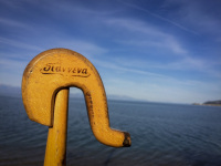 the handle of a wooden shepherd\'s stick which is signed with \"Ioannina\" you see in front of the blue gulf of corinth in diakopto