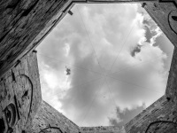 view from the yard of the castel del monte in puglia up to the clowdy sky, black-and-white