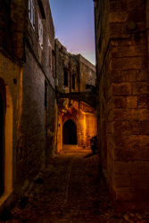 a wonderful sunsetlightes sky above a loveley iluminated  alley in the old town of rhodes