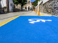 a big blue parking space for disabled people in the village agios isidoros on rhodes