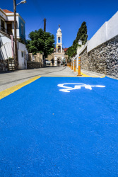 a big blue parking space for disabled people in the village agios isidoros on rhodes