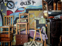 an antique trade presents furniture in front of his shop in monastiraki in athens