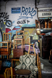 an antique trade presents furniture in front of his shop in monastiraki in athens
