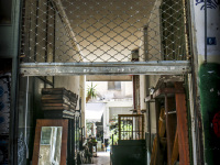 in a small backyard in monastiraki in athens furniture are presented for sale