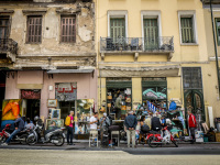 a street scene in monastiraki with old shops downstairs and windows with balcons upstairs