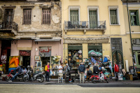 a street scene in monastiraki with old shops downstairs and windows with balcons upstairs