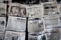 in plastic bags keeping antique newspapers are offered in a shop in monastiraki in athens