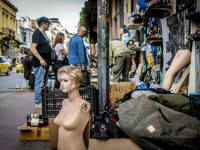 the naked bust of a display dummy and a lot of other flea market objects are standing at the street in front of shop in monastiraki in athens
