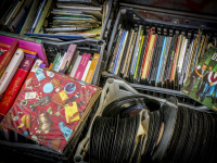 vinyl records, cd\'s and books in plastic baskets are for sale on a feal market in monastiraki in athens